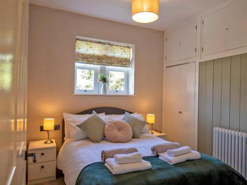 a bedroom with a large bed with towels on it at 3 Bed in Bakewell oc-90384 in Bakewell