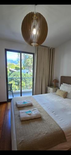 a bedroom with a large bed with two towels on it at Ocean Pearl Apartment W in Funchal
