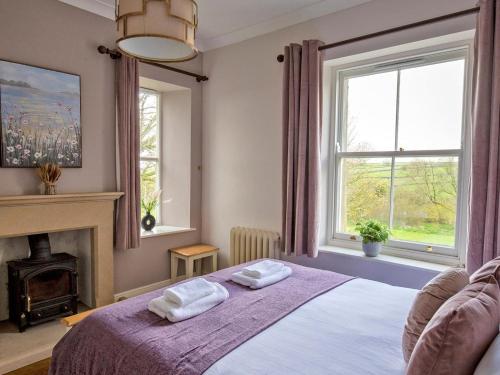 a bedroom with a bed with two towels on it at 7 Bed in Buxton oc-93808 in Tideswell