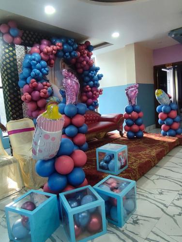 a balloon arch in a room with blue and pink balloons at Hotel Biswal Inn in Cuttack