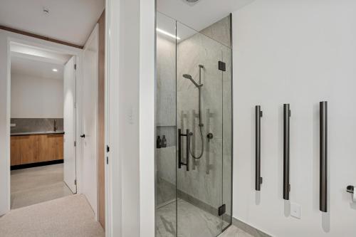 a bathroom with a shower with a glass door at Rubus St Residence by Sothebys Luxury Rental Homes in Wanaka