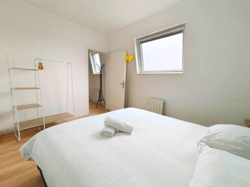 a bedroom with a large white bed with a window at L'Éclat du Miroir - AbsoluteHome in Croix
