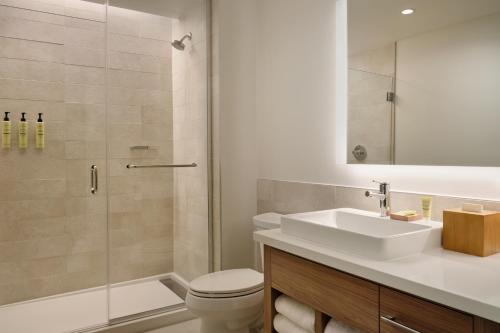 a bathroom with a toilet and a sink and a shower at Element by Marriott Pooler Savannah Airport in Savannah