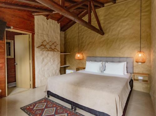 a bedroom with a large bed in a room at Mansión by Bernalo Hotels in Guatapé