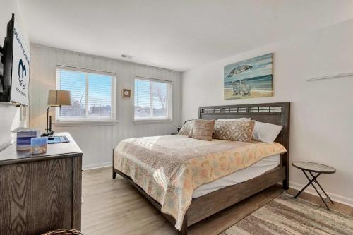 a bedroom with a bed and a desk and windows at Tiburon 5B in Ocean City