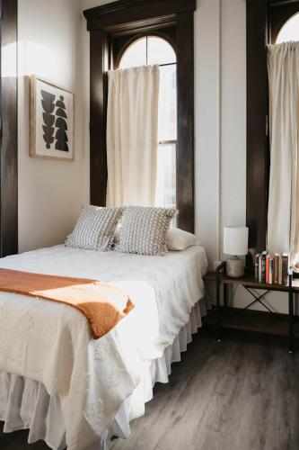 a bedroom with a large bed with a wooden headboard at The Neighborhood Lofts in Greencastle