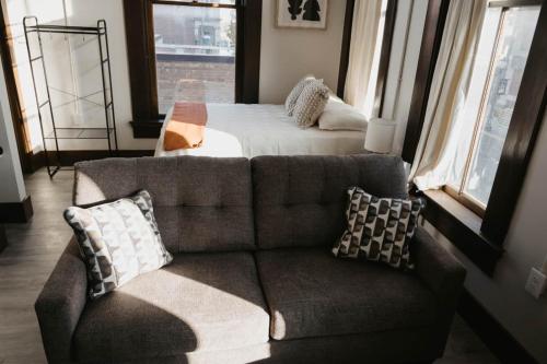 a living room with a couch and a bed at The Neighborhood Lofts in Greencastle