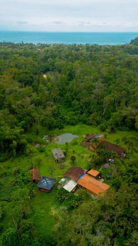 an aerial view of a house in a field at Drop House Hostel - Surf & Skate - Itamambuca in Ubatuba