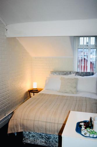 a bedroom with a large bed and a window at The Franklyn Hotel B&B in Blackpool