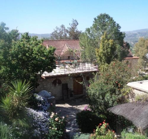 an external view of a house with a garden at Lantana Stone House in Lemona