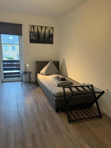a bedroom with a bed with a table in it at Im Point von Kiel City in Kiel