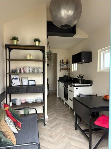 a kitchen with a table and a dining room at Renovated & private Tinyhouse Den Haag short stay appartment in The Hague