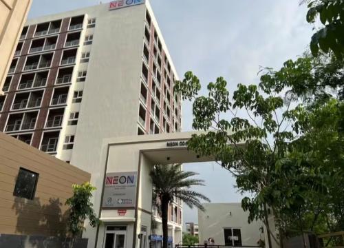 a large white building with a parking garage in front of it at Casa Dune in Pune