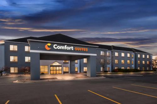 a rendering of a hotel with a comfort suites sign in a parking lot at Comfort Suites Stevens Point in Stevens Point