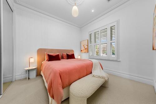 a white bedroom with a bed and a window at Luxury boutique bay retreat in Williamstown