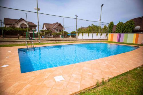 a swimming pool with blue water in a yard at Aspen Luxury Villa in Accra