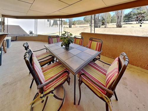 a wooden table with chairs and a table with a plant at Billy The Kid at Aspen Run 4A in Ruidoso