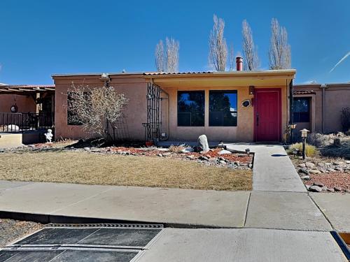 a house with a red door and a driveway at Billy The Kid at Aspen Run 4A in Ruidoso