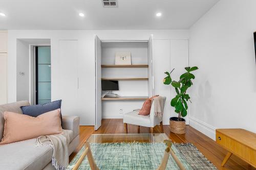 a living room with a couch and a table at Luxury boutique bay retreat in Williamstown