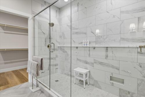 a bathroom with a shower with a glass door at Modern Lakefront Escape | The Twelve in Camdenton