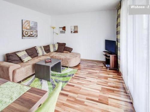 a living room with a couch and a television at Apartment Fe-Wohnung Augsburg by Interhome in Augsburg