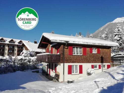a building covered in snow with the svensson card logo at Apartment Bella Vista by Interhome in Sörenberg