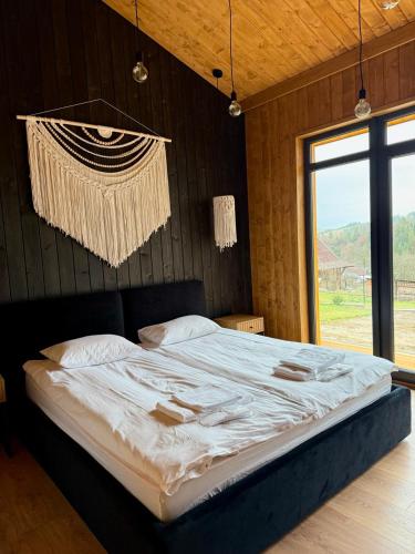 a large bed in a room with a large window at Мої Гори in Pilipets