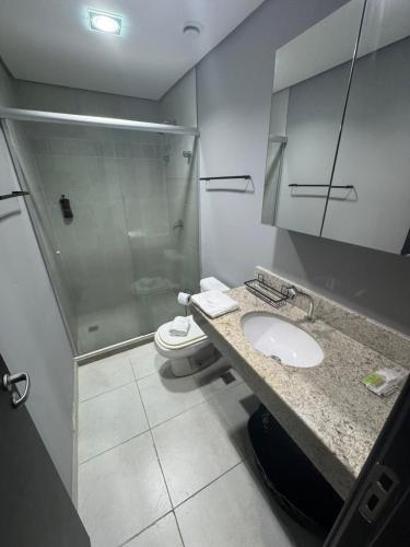 a bathroom with a toilet and a sink and a shower at Manaus Hotéis Millenium - Flat 804 in Manaus