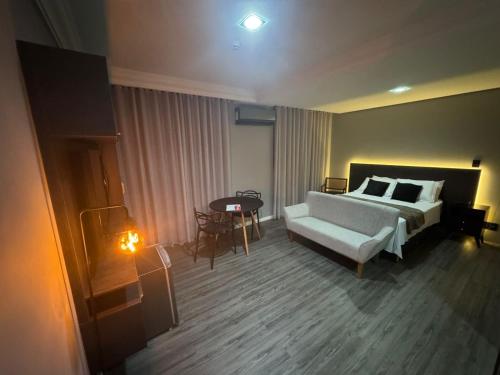 a hotel room with a bed and a table at Manaus Hotéis Millenium - Flat 804 in Manaus