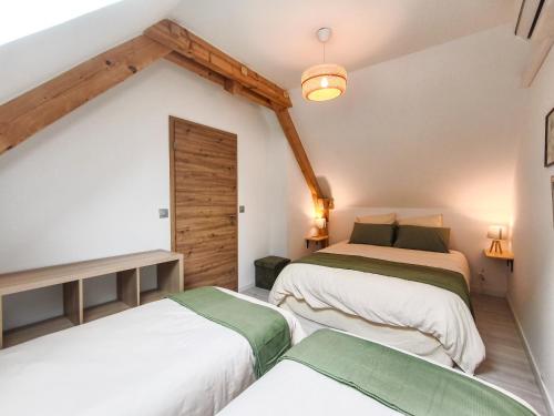 two beds in a room with a attic at Mackenheim - Parenthèse détente en Alsace - Terrasse & Parking in Mackenheim