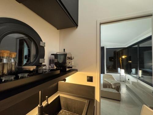 a kitchen with a sink and a large window at Villa Luna maison d'architecte in Marseille