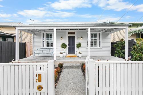 a white house with a white fence in front of it at Luxury boutique bay retreat in Williamstown