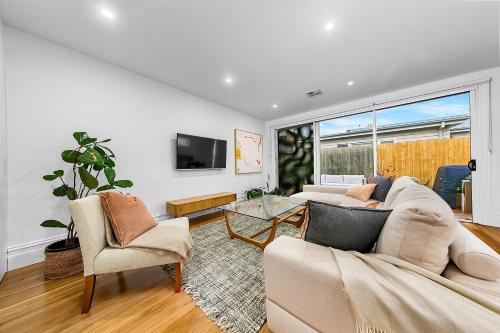 a living room with a couch and a table at Luxury boutique bay retreat in Williamstown
