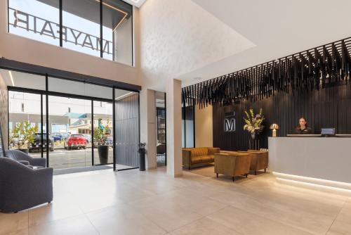 a lobby of a store with a woman sitting at a counter at The Mayfair in Christchurch