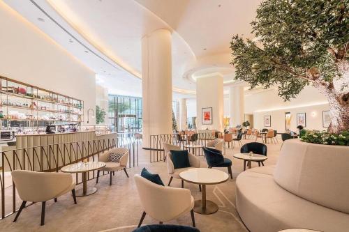 a lobby with tables and chairs and a bar at Emaar Marina Residences - formerly Address Dubai Marina in Dubai