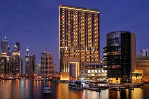 a city skyline with a large building in the water at Emaar Marina Residences - formerly Address Dubai Marina in Dubai