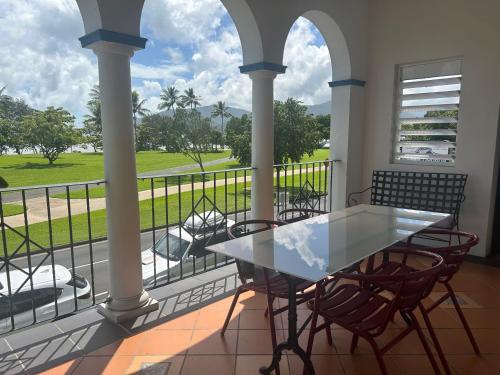 a patio with a table and chairs on a balcony at Floriana Boutique Hotel in Cairns
