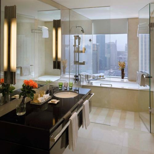 a bathroom with a tub and a sink and a shower at Emaar Marina Residences - formerly Address Dubai Marina in Dubai