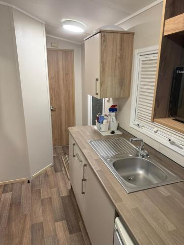 a kitchen with a sink and a counter top at Oakley Newquay Bay Resorts in Newquay Bay Resort