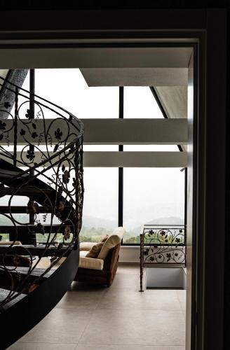 a room with a large window with a swing at Villa Gaia Novi Grad in Jablanica