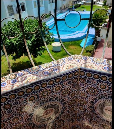 a view of a table with a pool in the background at Suite Home martil in Martil