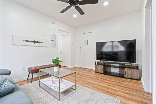a living room with a couch and a flat screen tv at Cozy Retreat 15Min to NYC, FIFA, Mall,FREE Parking - Apartment in North Bergen