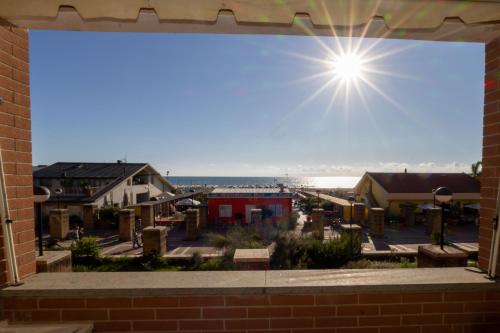 a view from the window of a brick building at Casa Onde & Tramonti in Marina di Grosseto