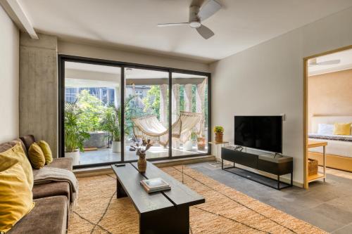 a living room with a couch and a tv at OWA Wellness Center in Mexico City