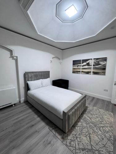 a bedroom with a bed and a skylight at The Villas in Rock Ferry