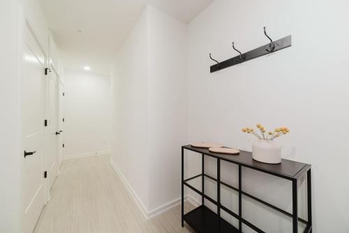 a hallway with a black table and a white wall at Inkwell Charlotte in Charlotte