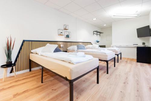 a row of beds in a room at Orange Suite Schliengen 2 in Schliengen