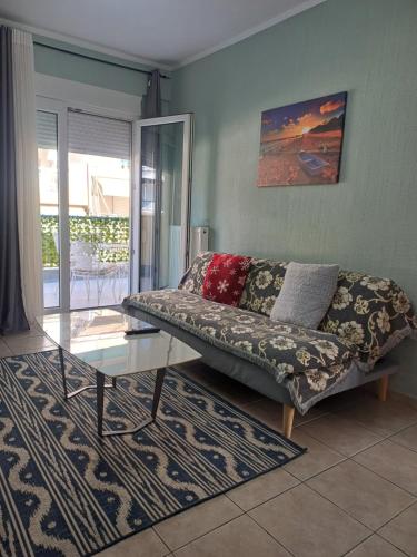 a living room with a couch and a glass table at VATA apartaments in Thessaloniki