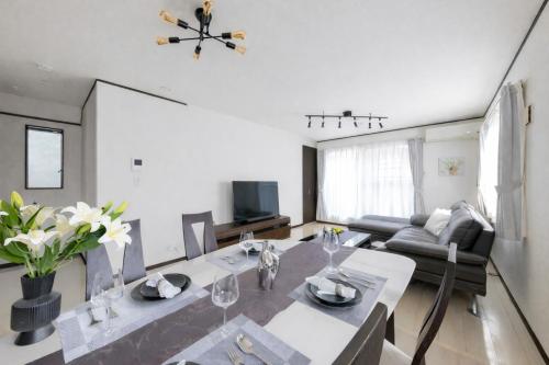 a living room with a table and a couch at A Family Friendly Spacious Villa - Easy to Tokyo Station & Conveniently Located for Tokyo Disney Resort & 1 min to Convenience Store in Tokyo