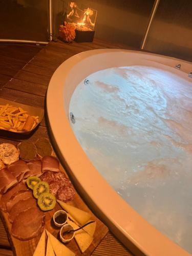 a jacuzzi tub filled with blue water in a room at VILLA PATTY ASSISI con SPA e Piscina in Assisi
